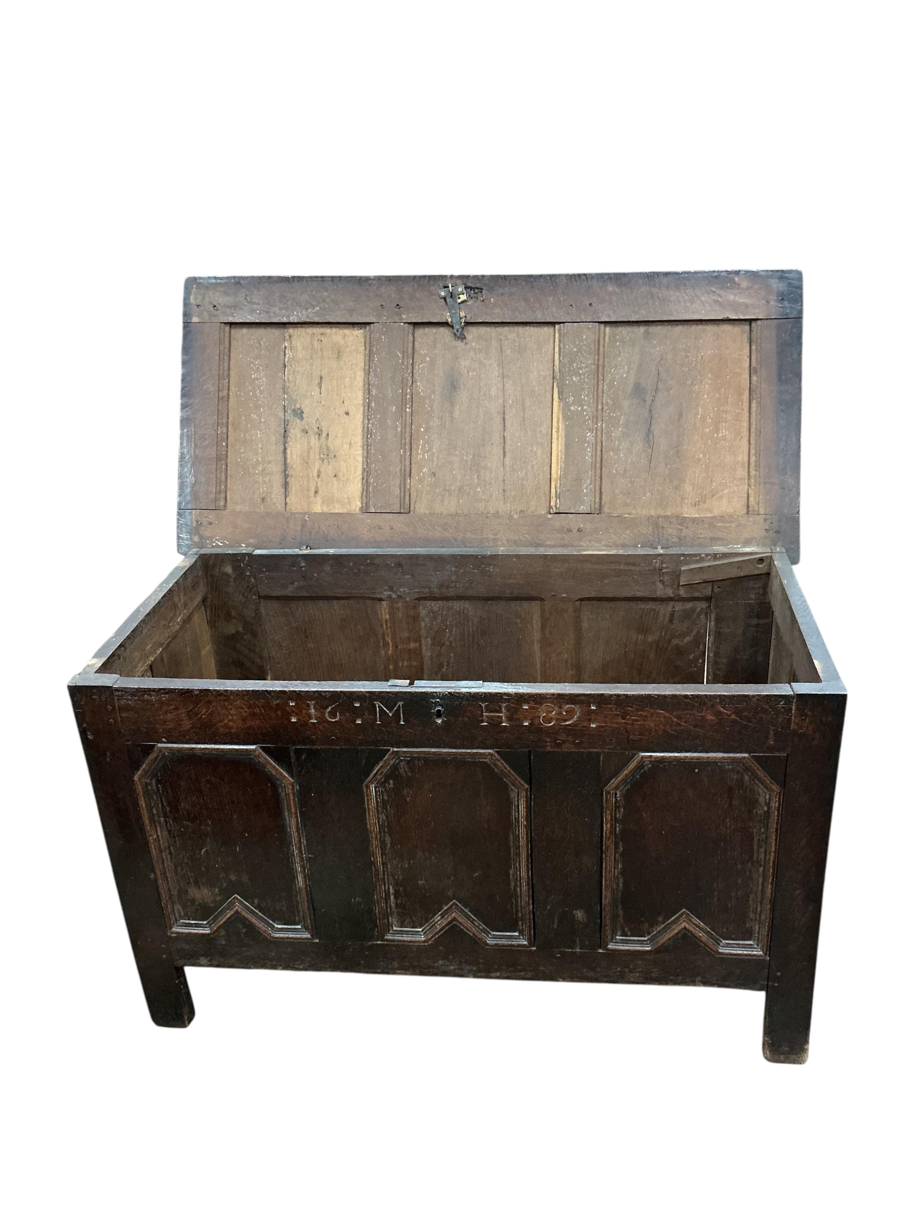 A late 17th century panelled oak coffer, dated 1686, width 116cm, depth 54cm, height 71cm